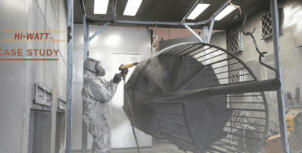 A person is spraying a coating on metal